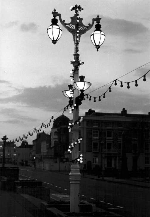 Black and white photograph. Evening lights, south coast