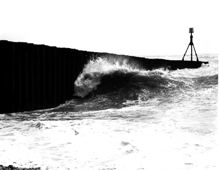 Black & white photograph. Breaking wave